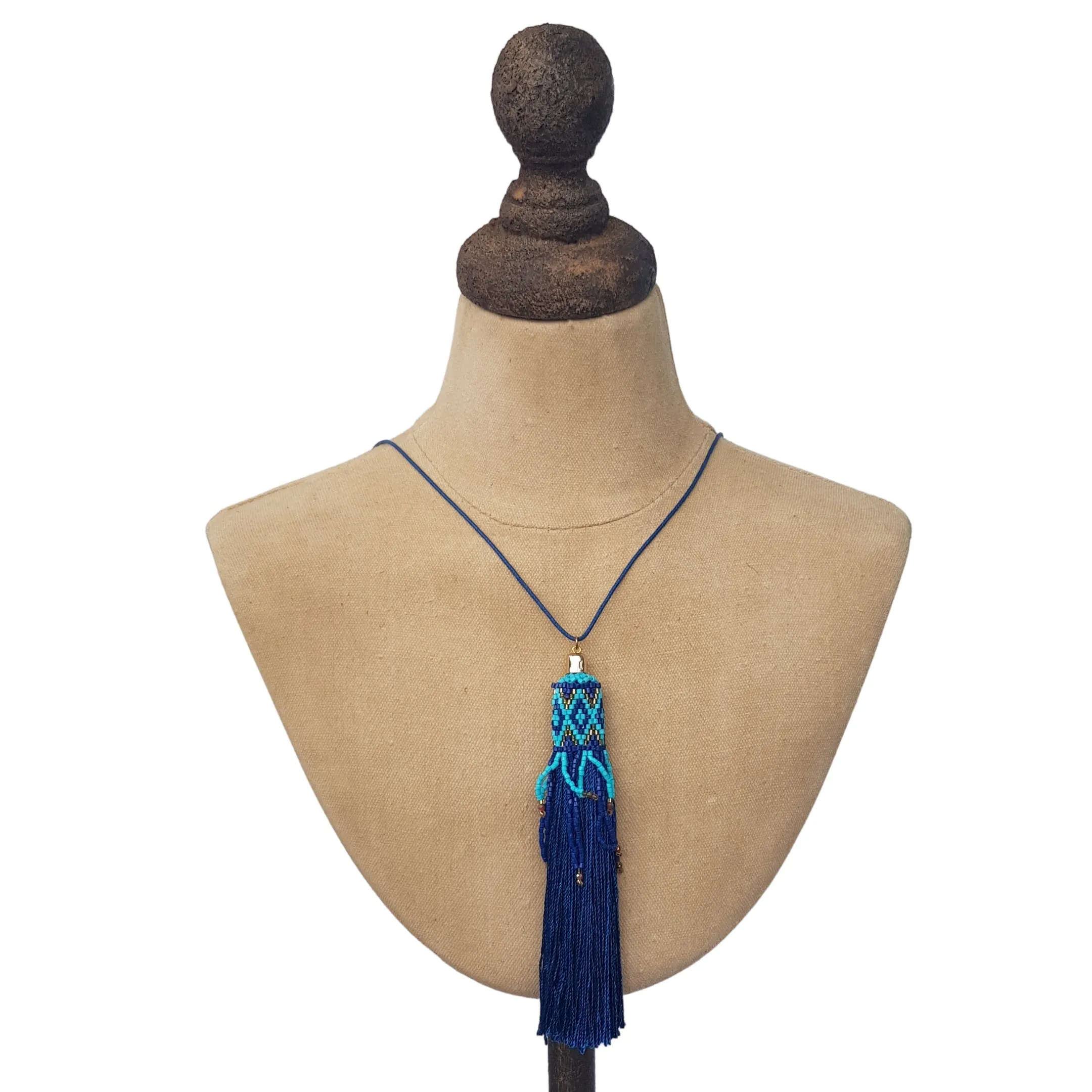 Blue tasselled necklace on cord